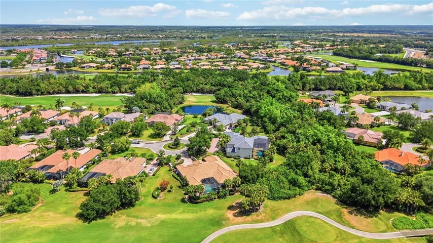 Aerial perspective showing the home tucked into a private, spacious setting.
