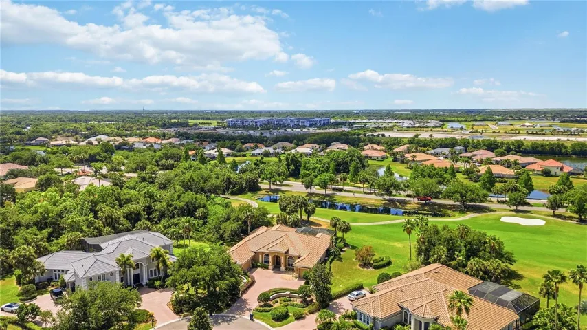 Aerial perspective capturing the private setting, golf views, and surrounding greenery.