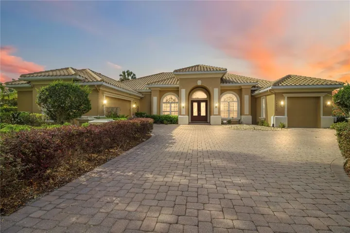 Warm evening curb appeal showcasing the home’s dramatic architecture.