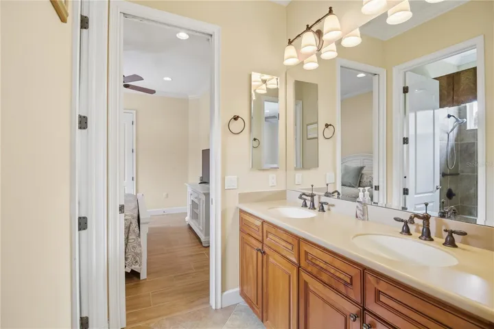 Jack and Jill bath with dual vanity, soaking tub, and separate shower.