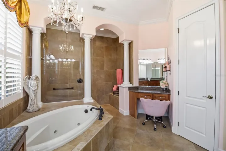 Primary bedroom with tray ceiling detail and peaceful views.