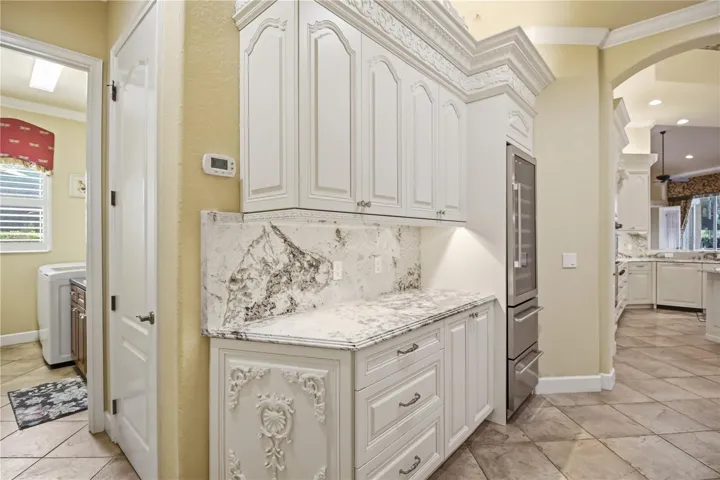 Butler’s pantry with cabinetry, counter space, and convenient serving area.