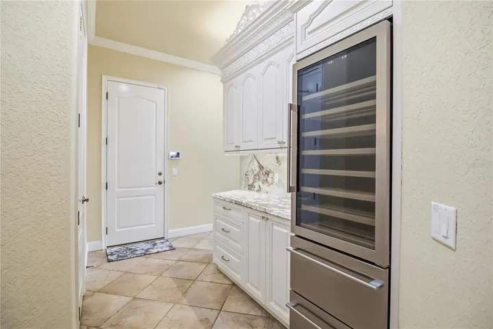 Bar and butler’s pantry with built-in wine fridge and convenient serving space.