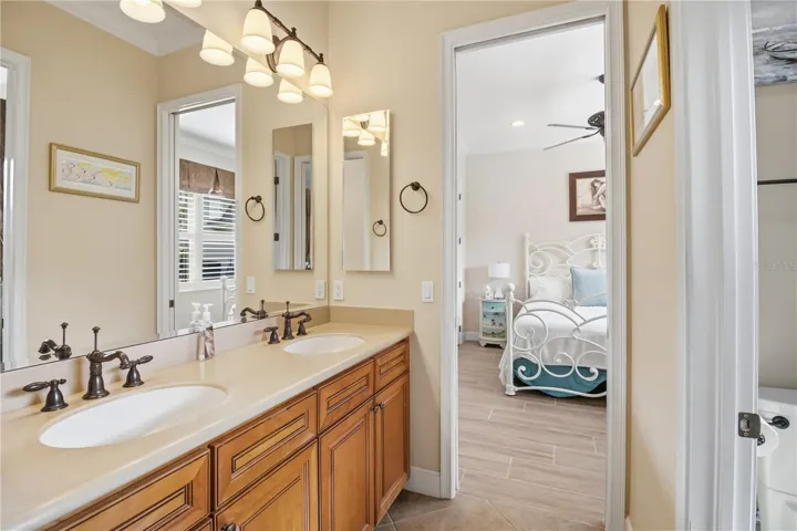 Jack and Jill bath with dual vanity, tub, and separate shower