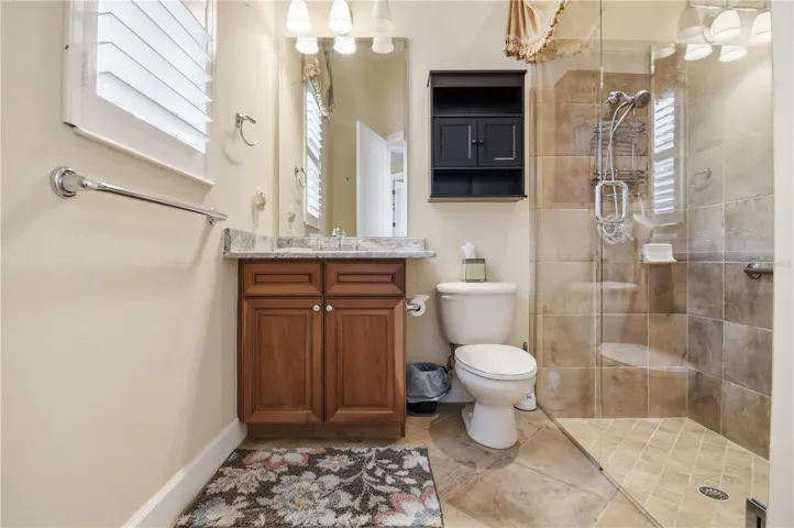 Full pool bath with walk-in shower, vanity storage, and classic finishes.