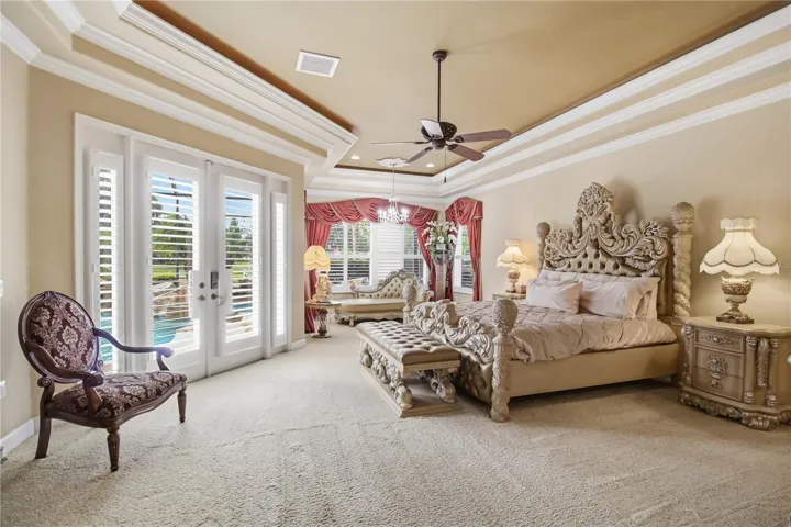 Spacious primary bedroom with tray ceilings, built-in lighting, and room to unwind.
