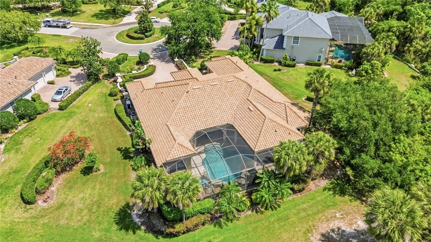 Aerial view emphasizing the wide lot, circular drive, and estate-style presence.