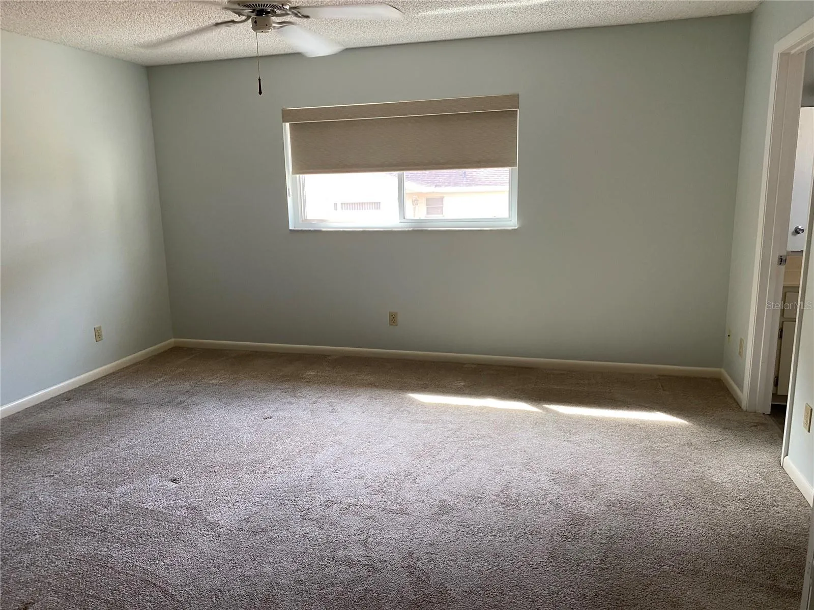 main bedroom large window with window shades