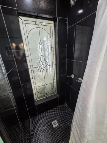 Granite Shower with Stained Glass Panel