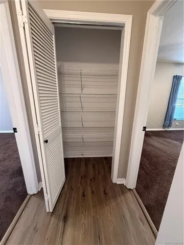 Linen closet at end of hallway
