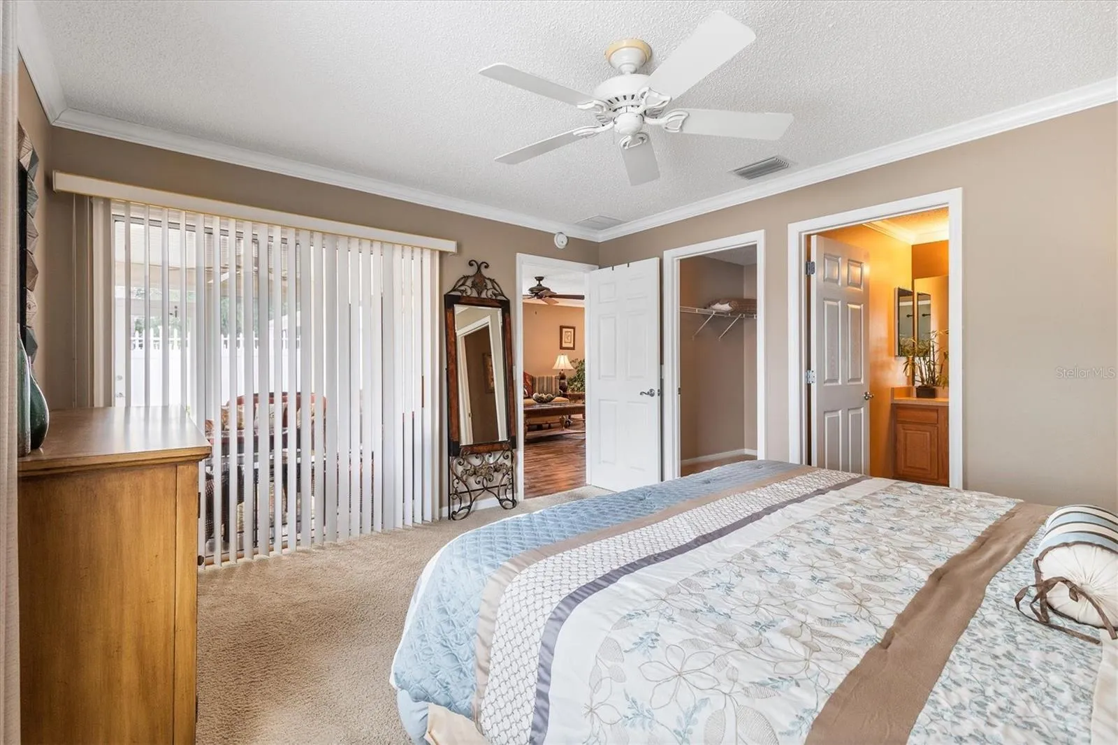 PRIMARY BEDROOM LOOKING TOWARDS BATH, WALK IN CLOSET AND LANAI