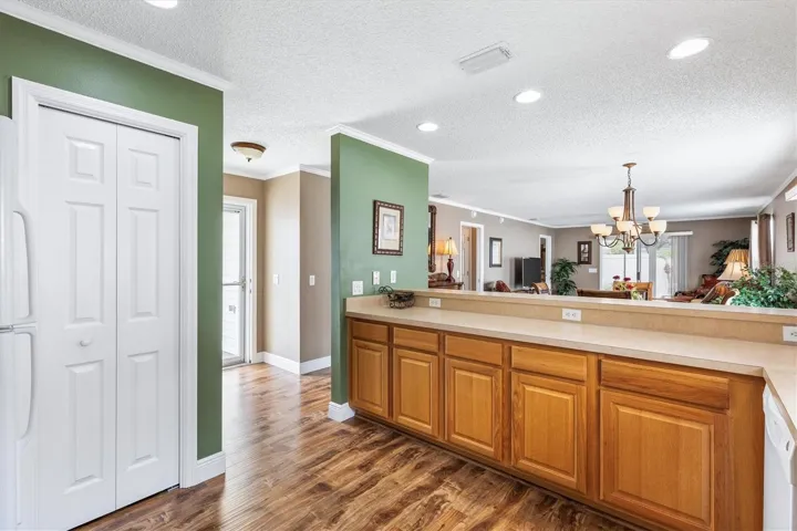 KITCHEN LOOKING TOWARDS FRONT DOOR, DINING AND LIVING ROOM