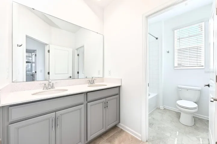 Two additional bedrooms and another full bath provide ample space for family or guests.