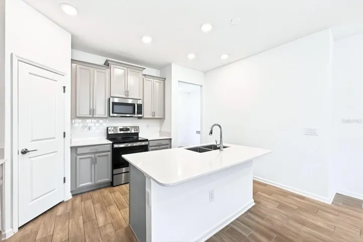 With room for counter-height stools, the Kitchen island doubles as a comfortable spot for quick meals and offers extra prep space.