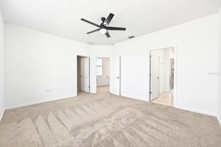 Upstairs, the Primary Suite offers a relaxing retreat, complete with a walk-in closet featuring CUSTOM STORAGE and an en suite bath.