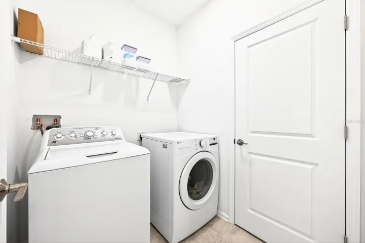 The UPSTAIRS LAUNDRY ROOM includes a washer and upgraded dryer (2024) for added convenience.