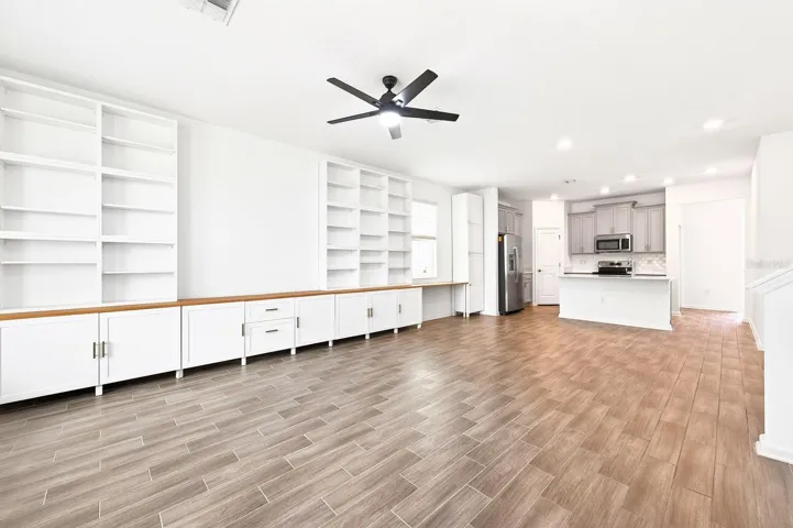 The WOOD-LOOK TILE FLOORING throughout the main living areas adds durability and modern appeal, while the OPEN LAYOUT offers flexibility for both living and dining spaces.