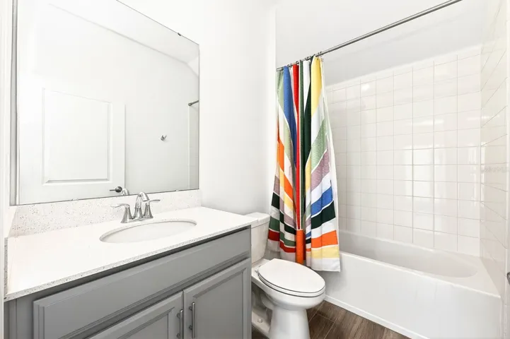 A MAIN-FLOOR BEDROOM and full bath provide excellent flexibility for guests, a home office, or multigenerational living.