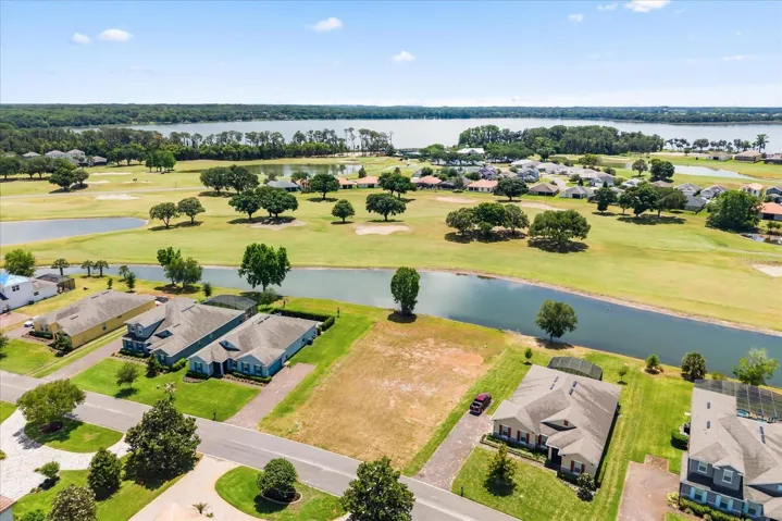 Lot from front with pond behind and Lake Beauclair in distance