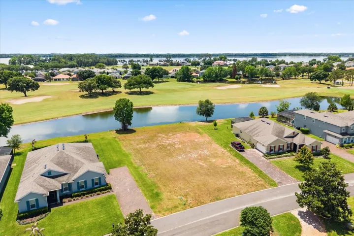 Lot from front with pond behind and Lake Beauclair in distance