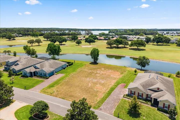 Lot from front with pond behind and Lake Beauclair in distance