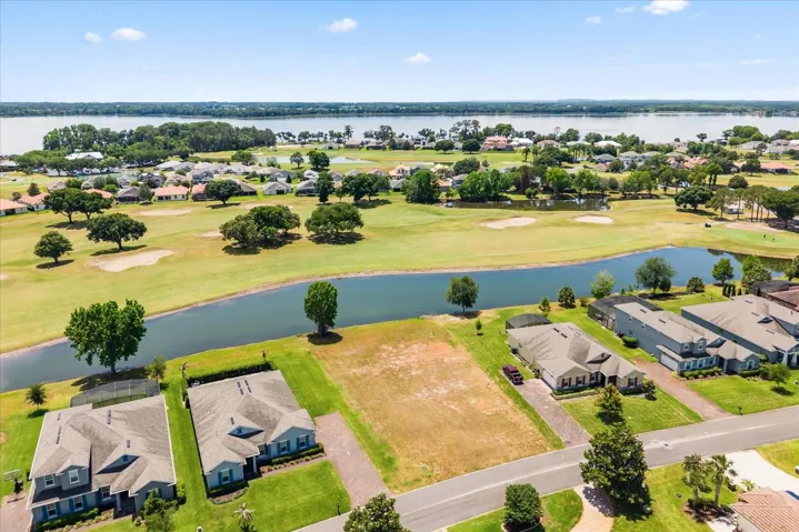 Lot from front with pond behind and Lake Beauclair in distance