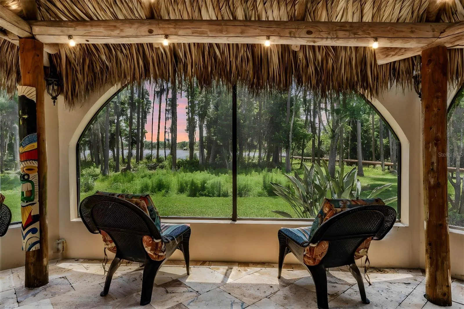 Tiki Hut with views of the Pool, Lake and Backyard.