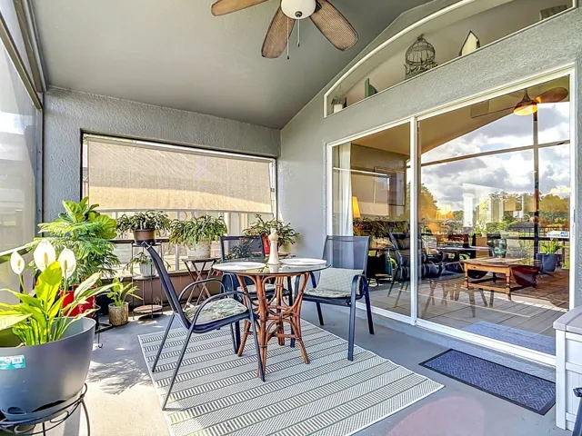 Generously sized covered screened-in porch with ceiling fan.