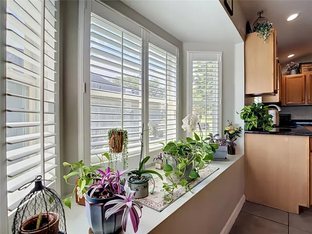 Window box for sunlit plants in your bright kitchen. Notice the plantation shutters.