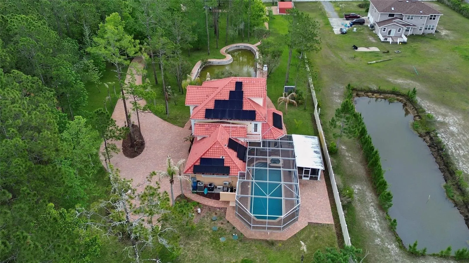 Drone view of property with pond in the back