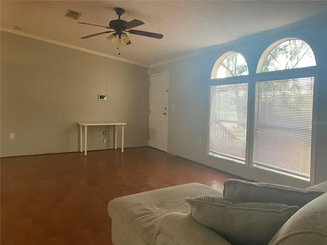 The living room has large windows to allow natural light to filter inside the home.