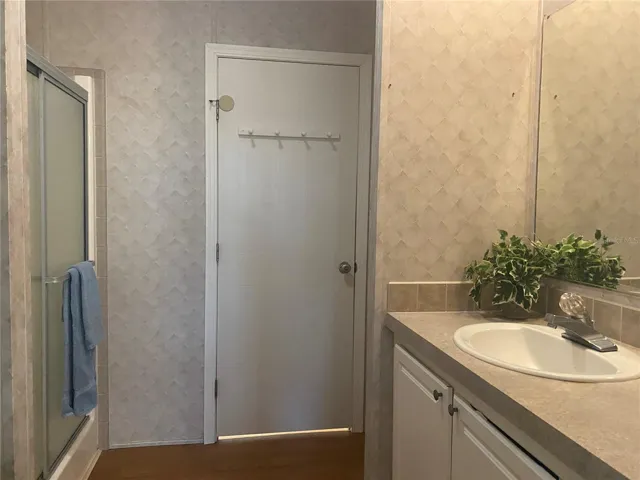 Primary bath with high-top vanity.