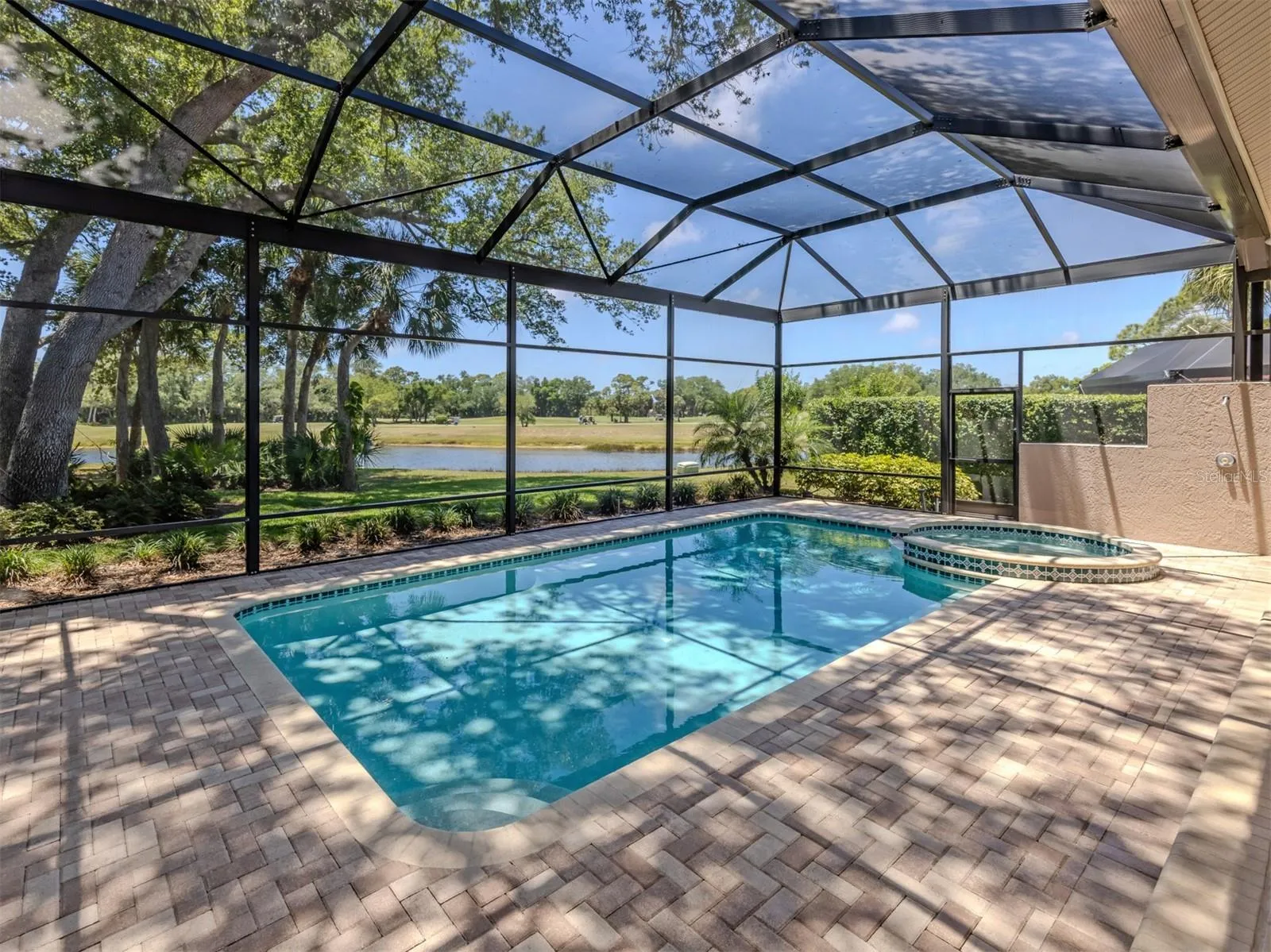 Layered pavered heated pool and spa with outdoor shower.