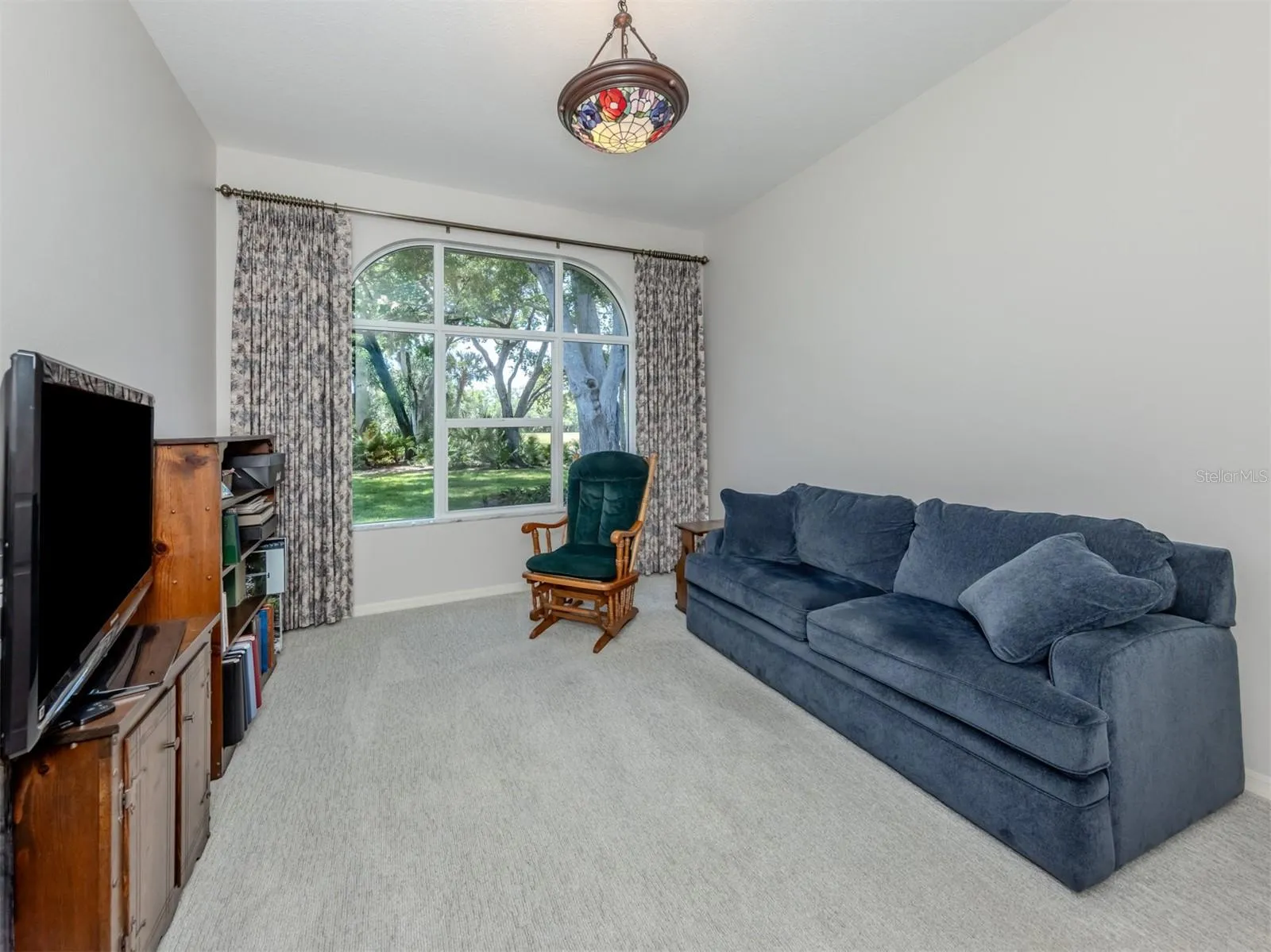 Third bedroom with picture window view; currently used for entertainment