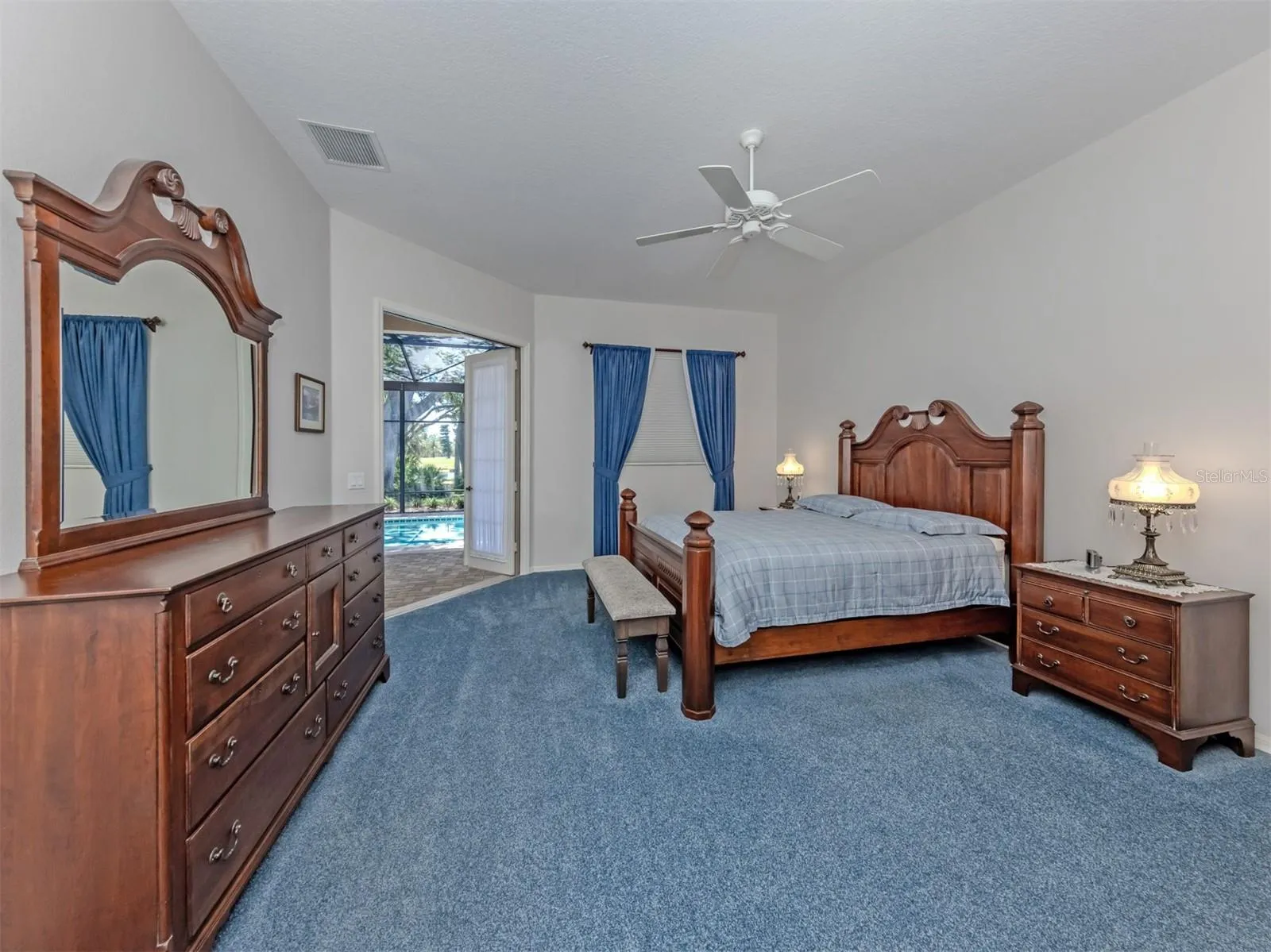 Spacious Primary suite with French doors to lanai and two walk-in closets.