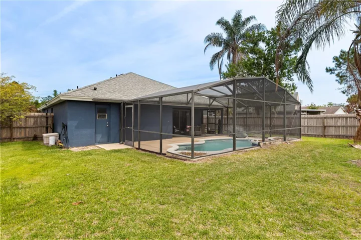 Back exterior with screened-in pool