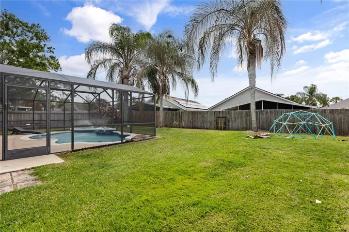 Backyard with screened-in swimming pool