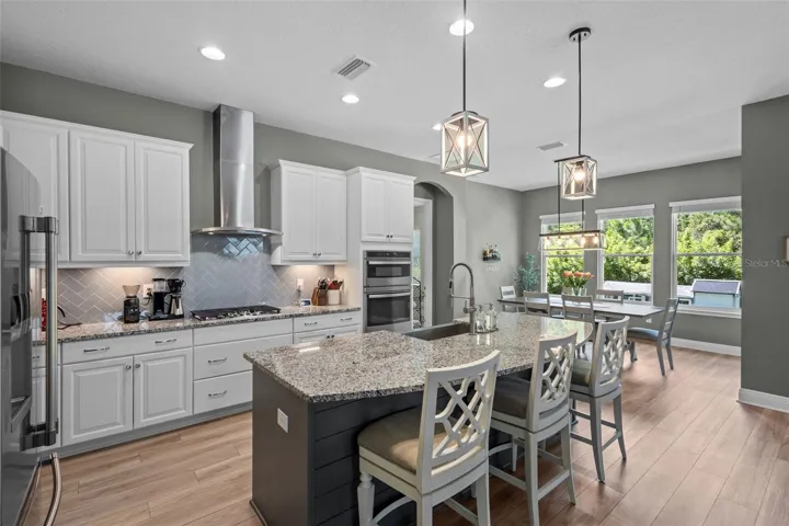 Spacious kitchen with tall cabinetry, stainless steel appliances, and generous storage.