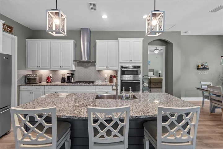 Spacious kitchen with tall cabinetry, stainless steel appliances, and generous storage.