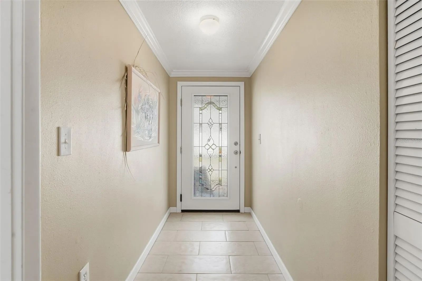 Small hallway between kitchen and Guest Bedroom. Current Owners do not used this door. Could be a mini-office nook, built-in storage, drop zone, bar/coffee station or a folding station for laundry.