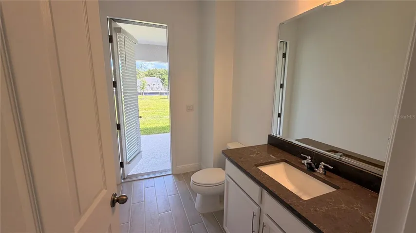 1st Floor Half-Bath with exterior access to rear Lanai