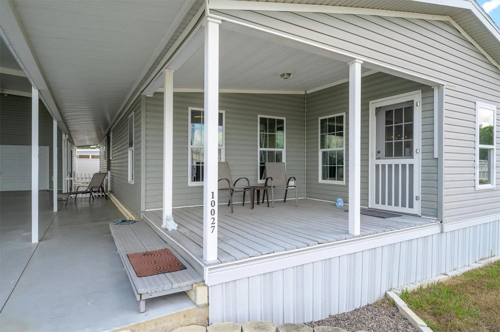 Front porch entrance leading in to the front sunroom, flex space