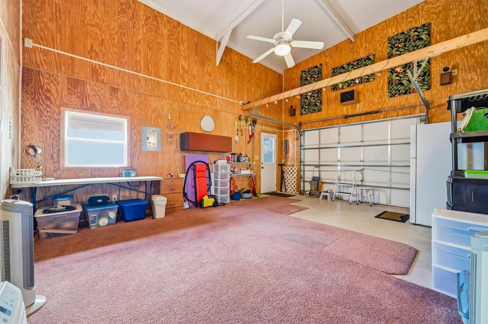 Interior of garage side currently used as a workout room and tack room