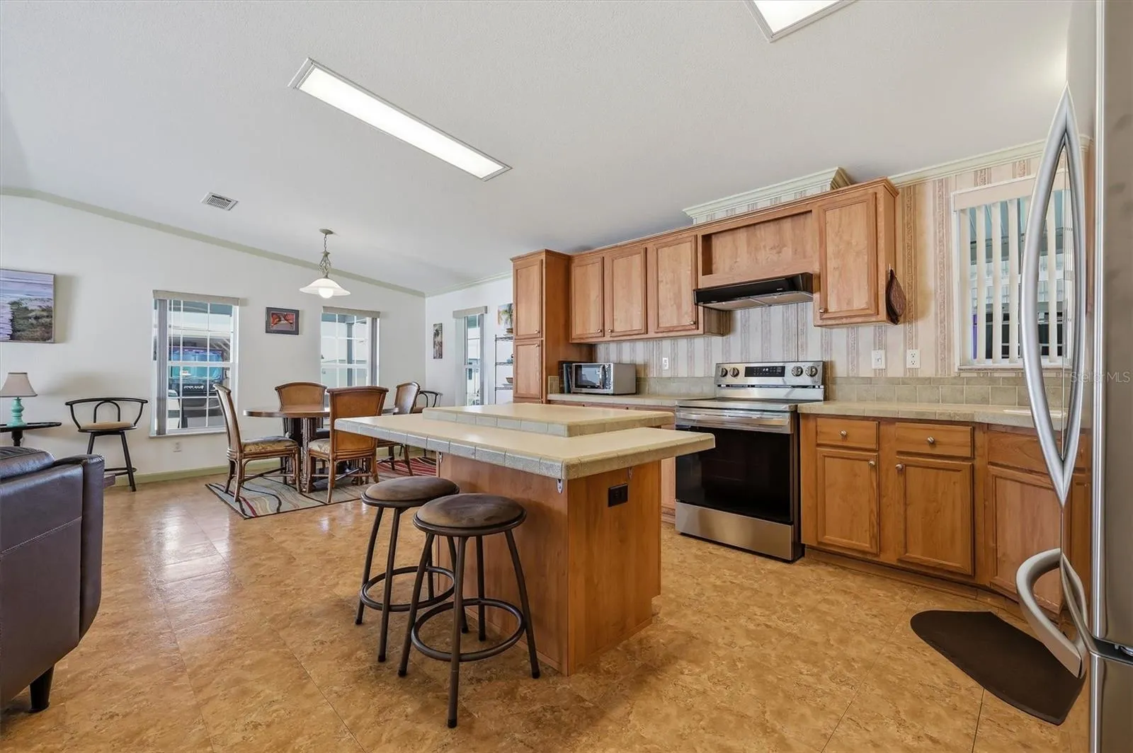 Open kitchen with a lot of cabinets. All appliances remain.