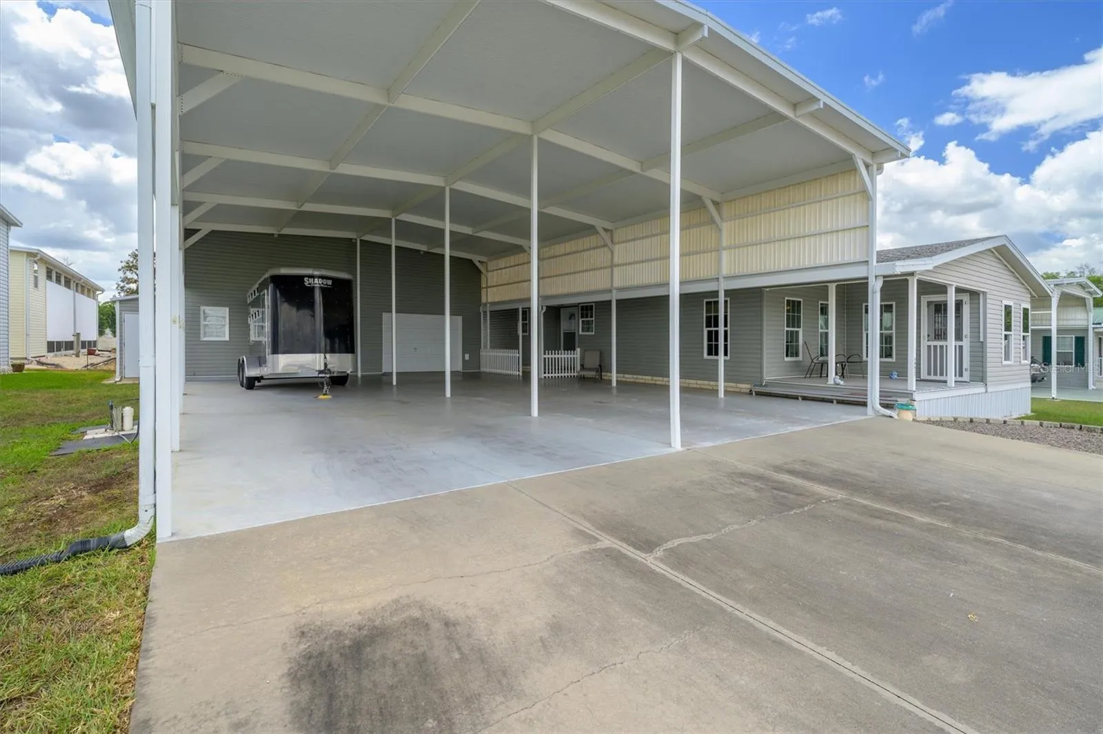 This horse trailer gives you a reference to how tall and large this RV port is.  Currently owner parks a large truck in front of the trailer,  and 2 SUVs fit on the other side.   There are two front entrances from this port.  The main entrance or the front porch entrance.