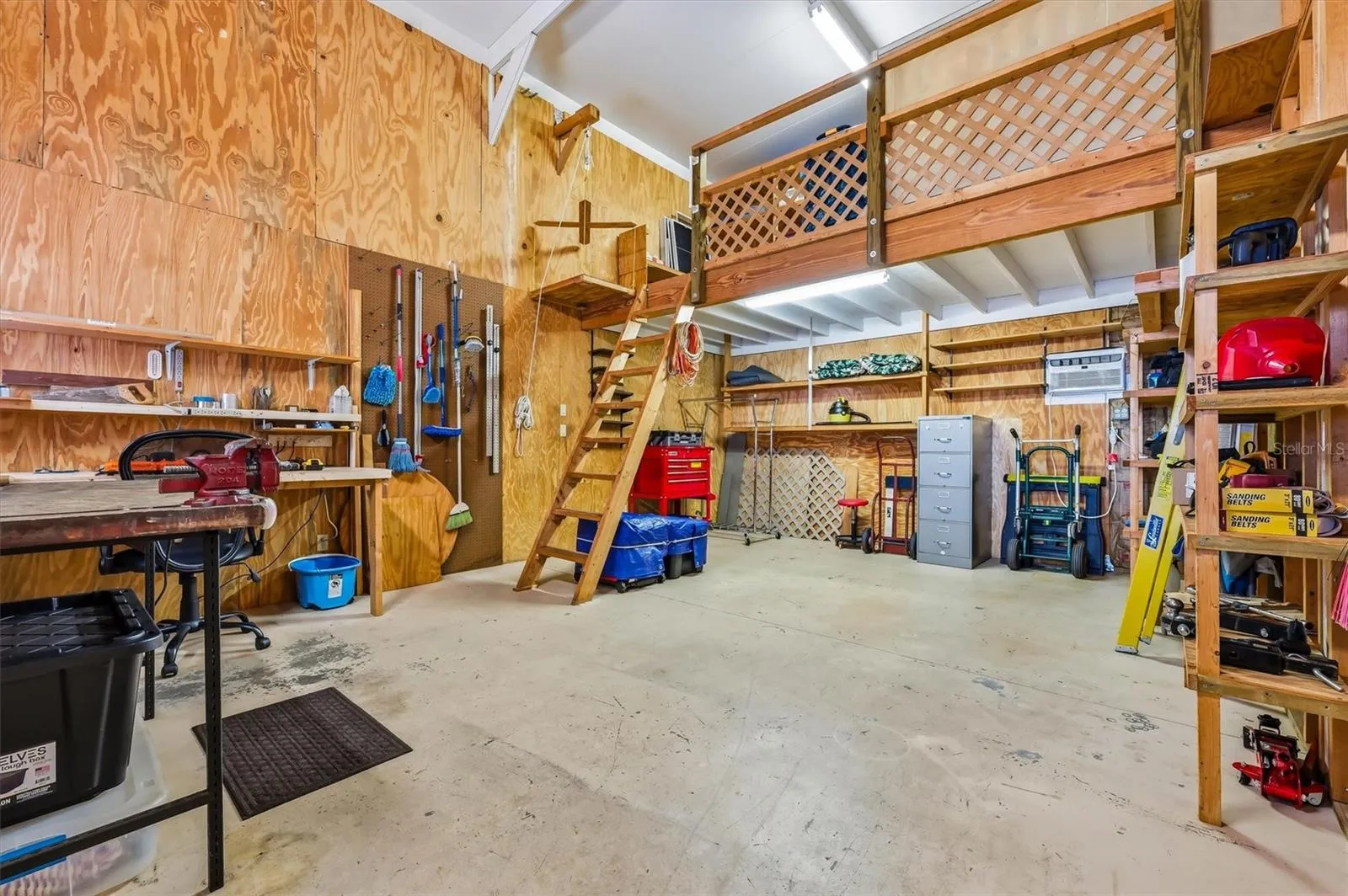Large workshop with loft for storage, and pulley lift to bring things up.  Shelving remains.