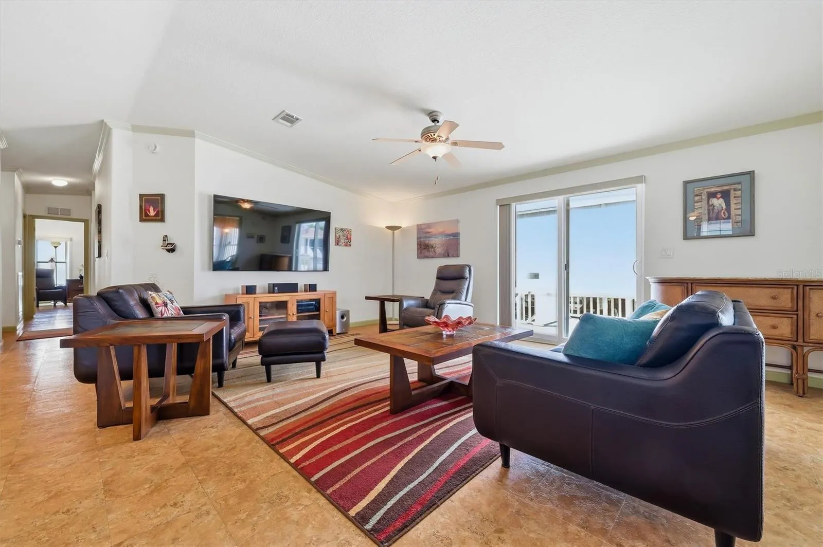 Living Room with sliding doors leading out to a small side porch to yard.