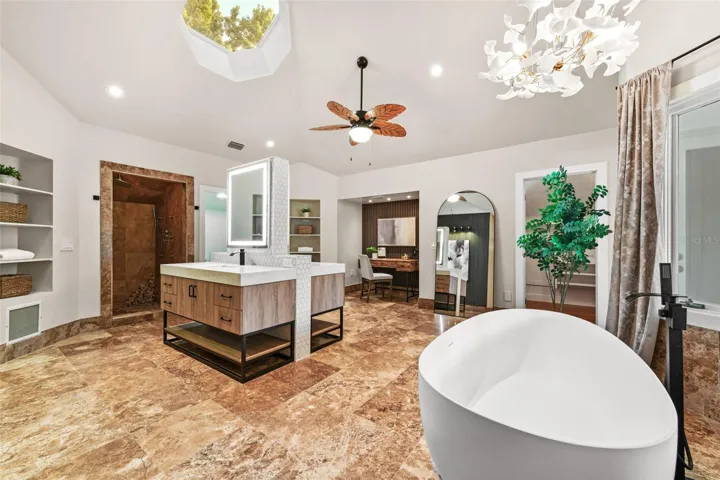 The remodeled primary bathroom was updated recently & features dual vanities, a sky light, a freestanding soaking tub, a private balcony and 3 closets!