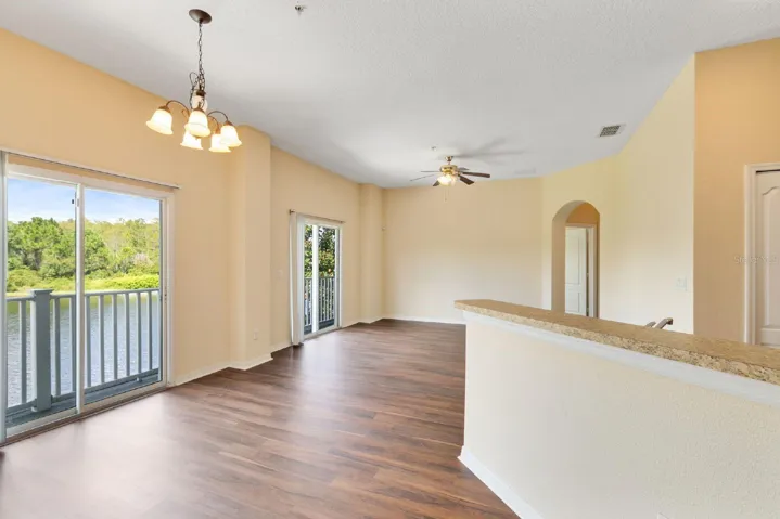 Large sliding glass doors in the Living and Dining areas frame PEACEFUL POND VIEWS, bringing the outdoors in and creating a serene backdrop to everyday living.