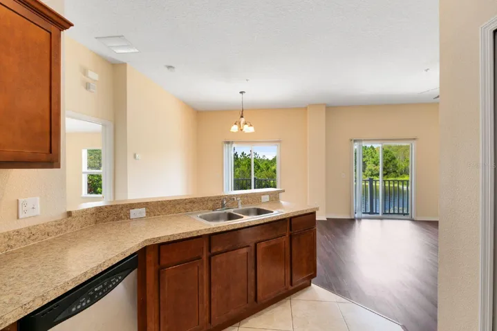The Kitchen offers AMPLE CABINETRY and COUNTER SPACE, stainless steel appliances, and a convenient breakfast bar, making it both functional and welcoming.
